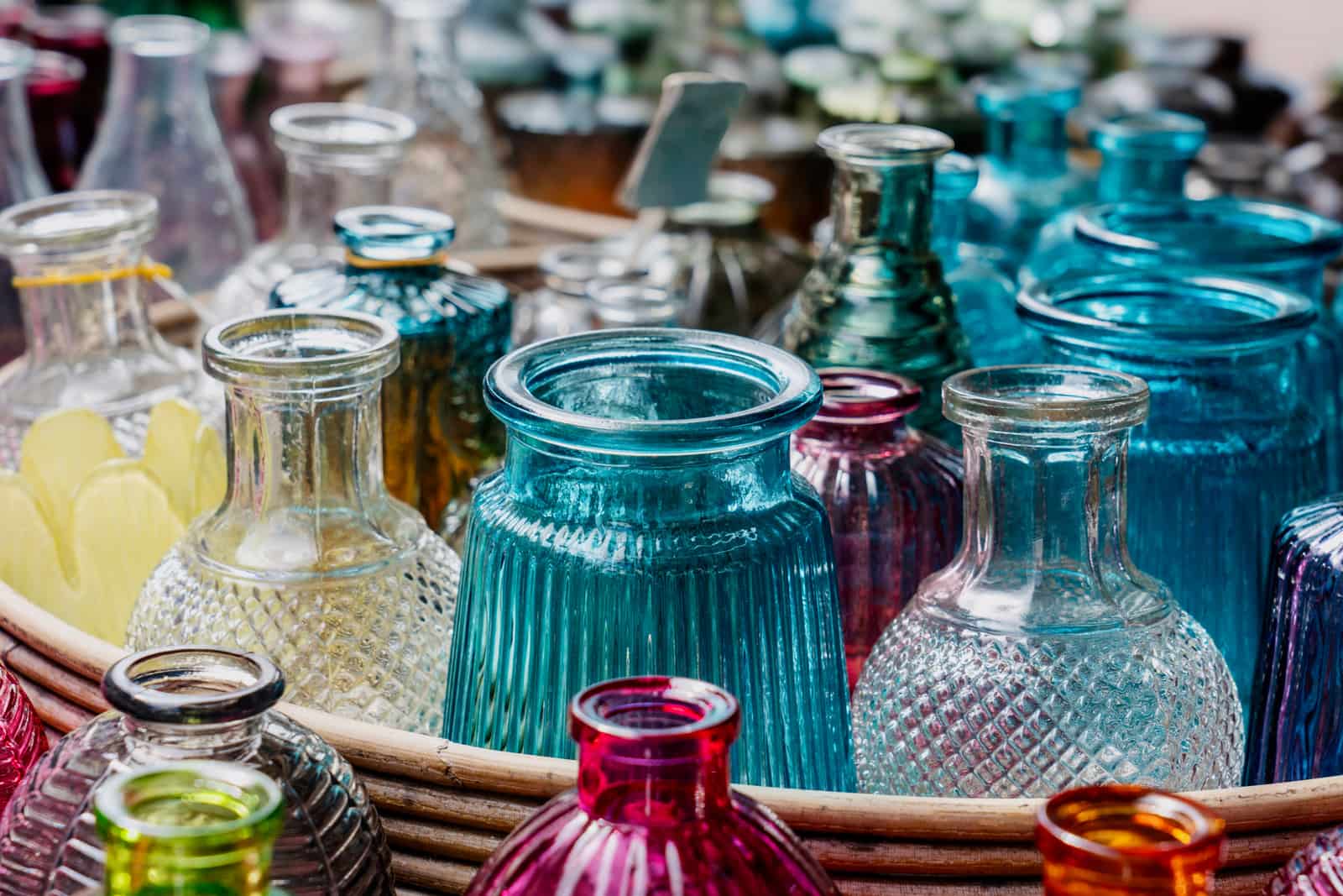 Glass bottles of several sizes arranged on a white background