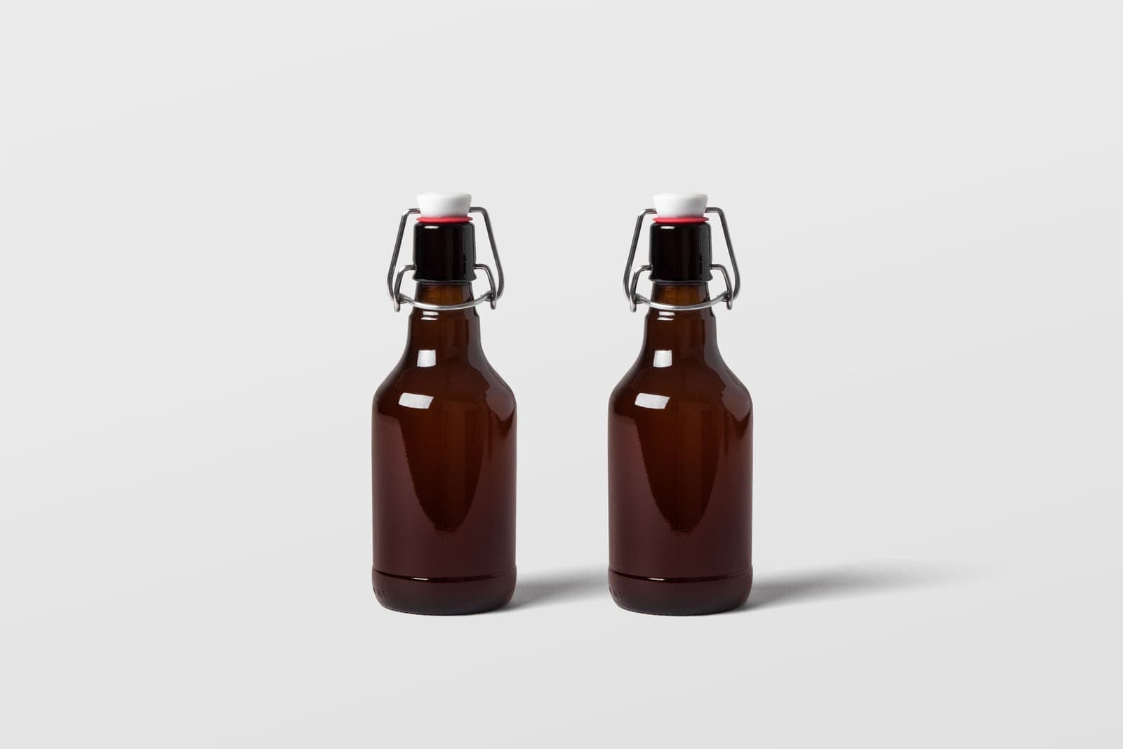 A swing-top glass bottle with a flip cap, photographed in bright daylight
