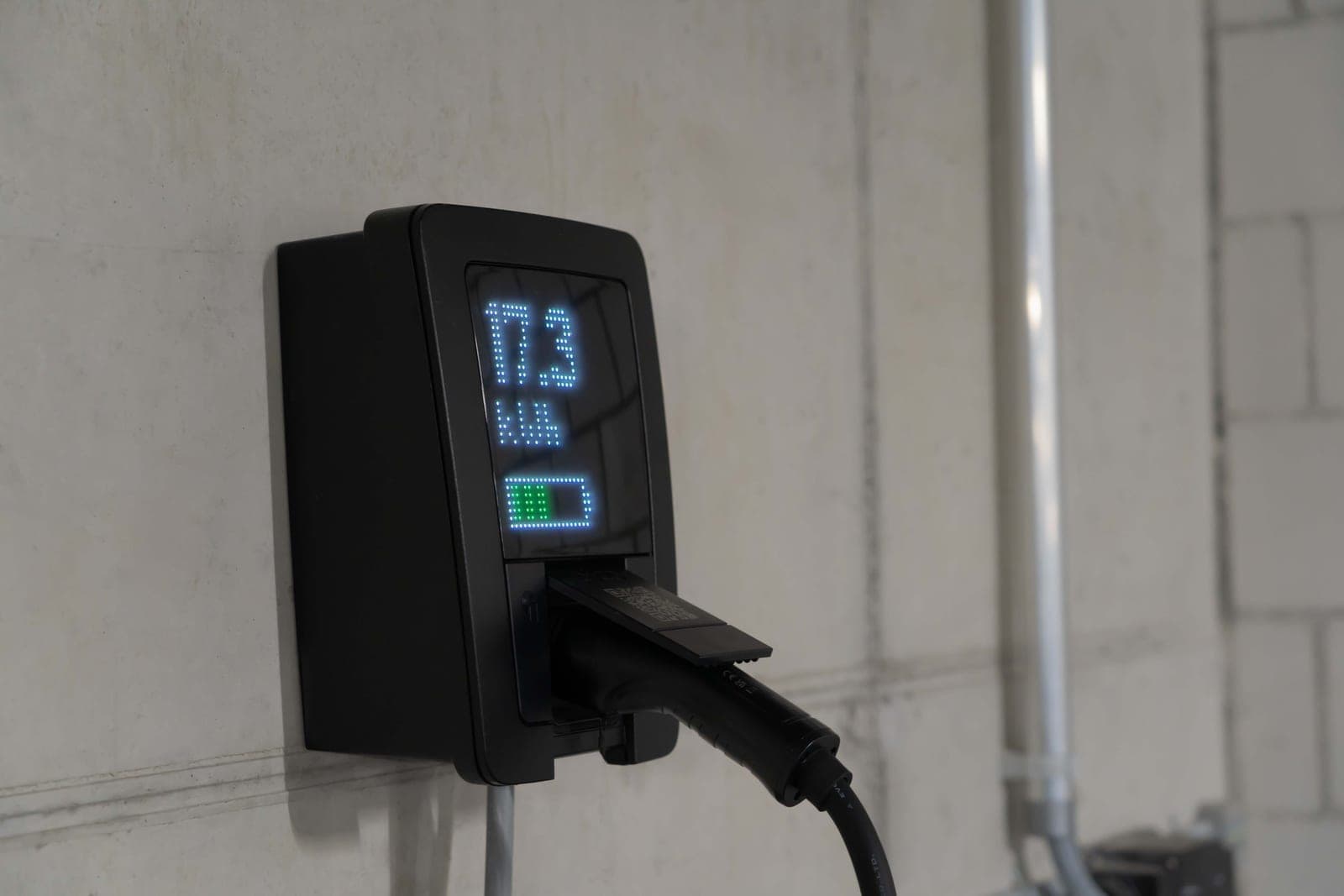 A digital controller with a display and a plug on a bright surface
