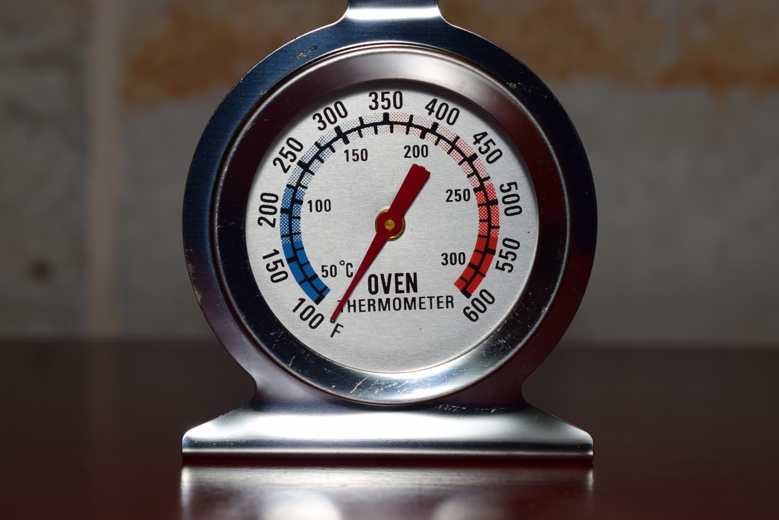 A thermometer beside a bright kitchen window