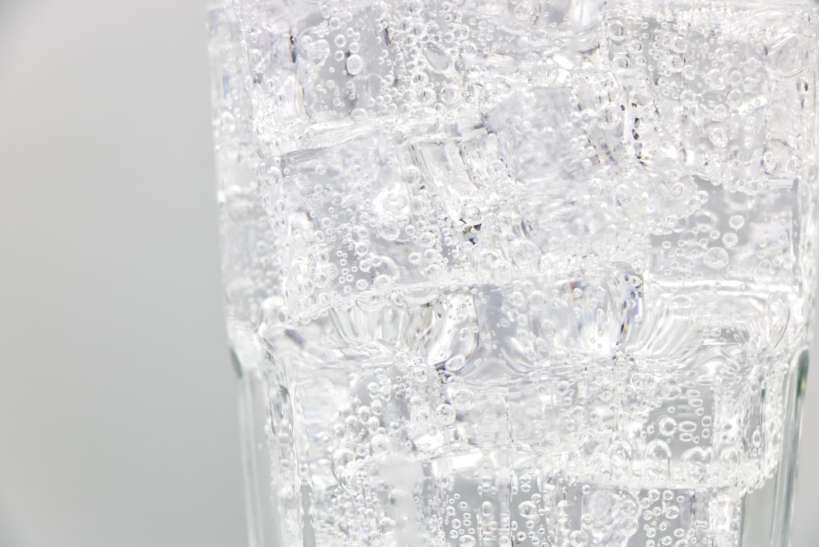 Close view of bubbles rising in a glass of clear drink
