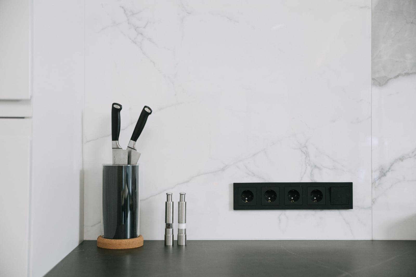 A clean, minimal white kitchen counter in bright daylight