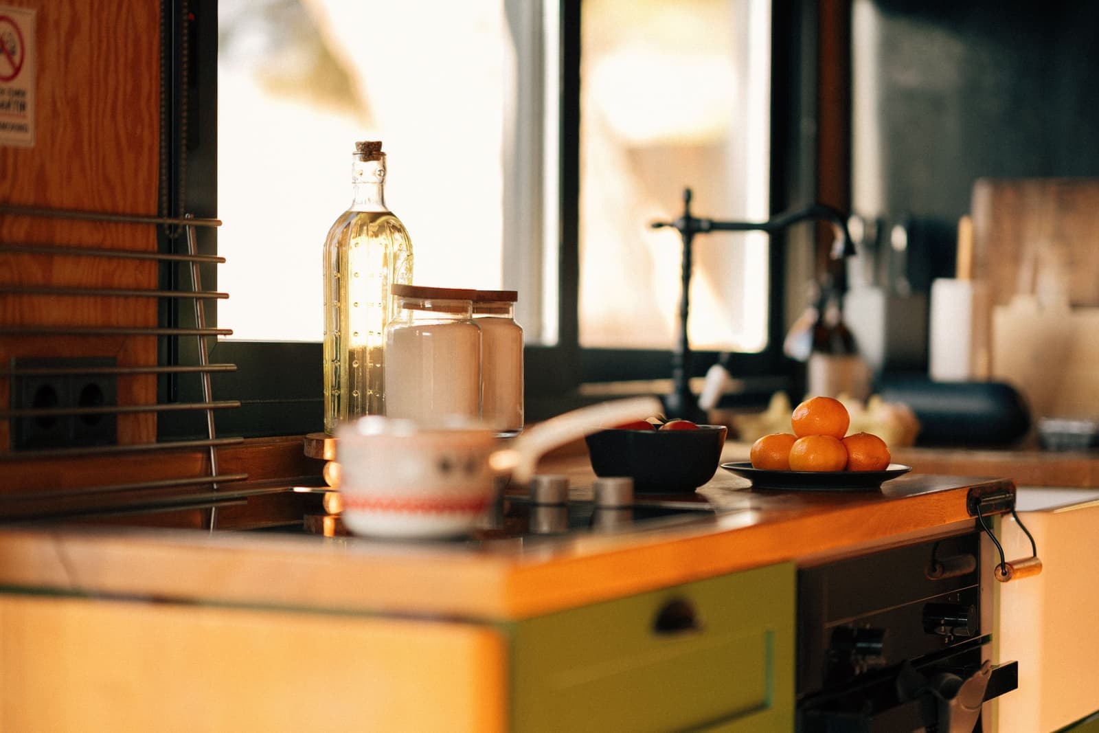 Fruit and bottles arranged on a bright kitchen bench
