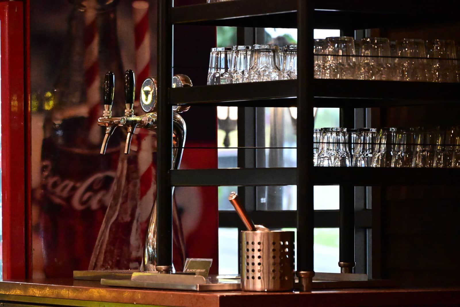 A large beverage dispenser with a tap standing on a kitchen counter