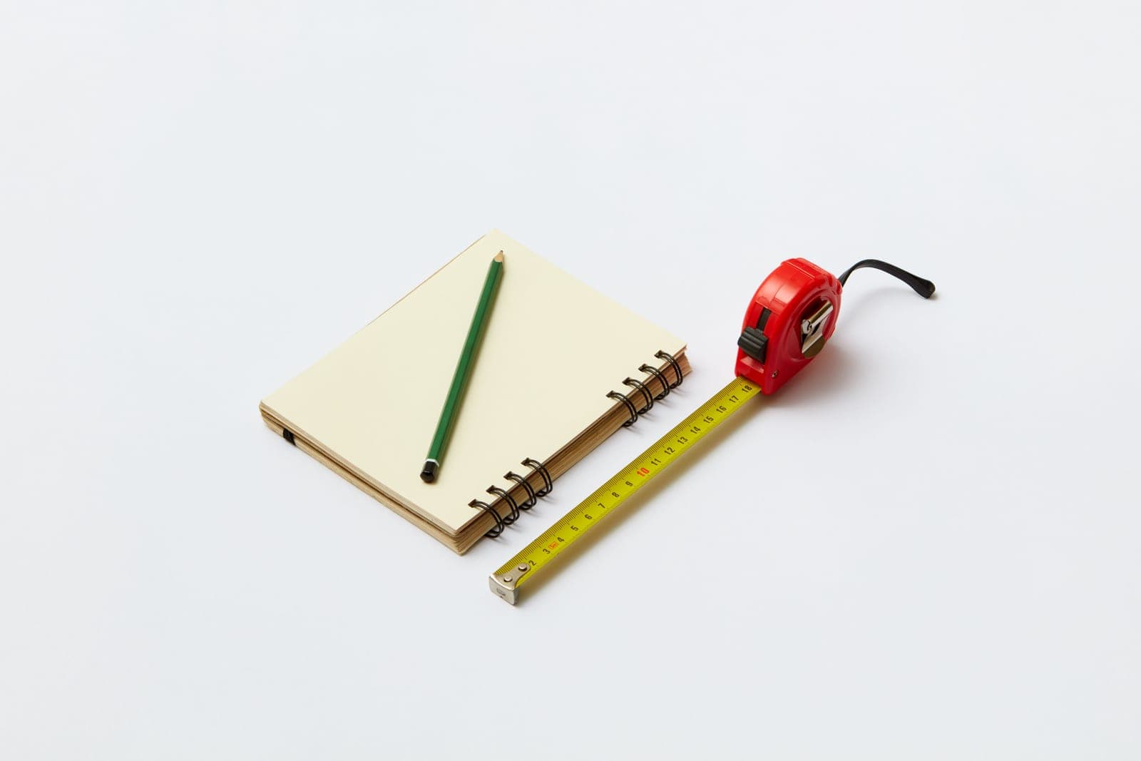 Measuring tools and notes on a bright white desk